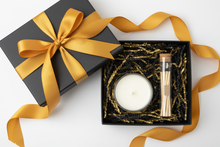 Load image into Gallery viewer, black gift box with mustard yellow ribbon. The candle does not have a label.  Inside the box is a clear transparent glass candle and a glass tube of matches.  The candle and matches is sitting on black &amp; gold crinkle paper filling.
